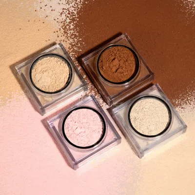 Showcases the variety of shades and fine powder texture of the makeup product, demonstrating color options and quality to potential buyers.