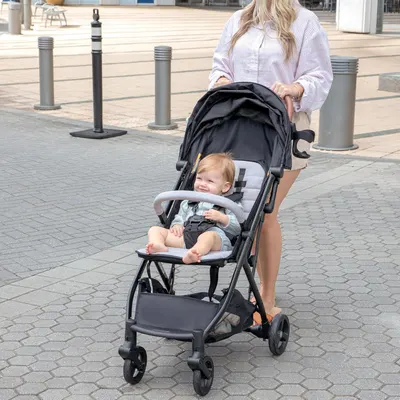 Shows the product being used in a real-world urban setting, demonstrating its practicality and suitability for everyday outings.