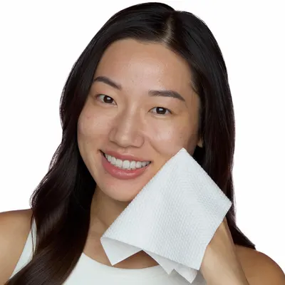 Highlights the softness of the product by showing a smiling woman holding it against her face, implying comfort and gentleness on the skin.