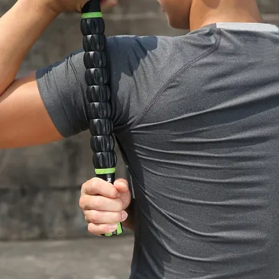 Demonstrates the correct way to use the muscle roller on the back, showing proper grip and positioning. Shows the product being used in a real-world context, helping customers visualize how they…