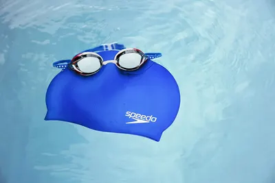 Shows the product in a realistic swimming context to demonstrate its use and appeal to swimmers.