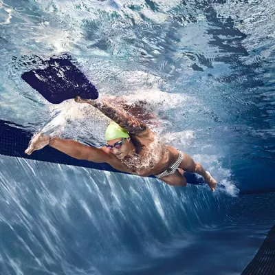 Showcases the product in action during swimming, demonstrating its suitability for high-performance aquatic activities.