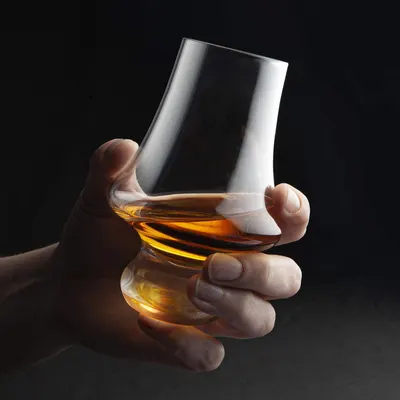 Showcases the product in use, emphasizing its premium design and the luxurious experience of enjoying a fine whiskey.