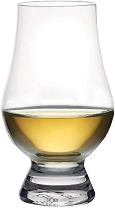 Shows the product (a whiskey glass) in use with liquid inside, demonstrating its appearance and functionality in a real-world context.