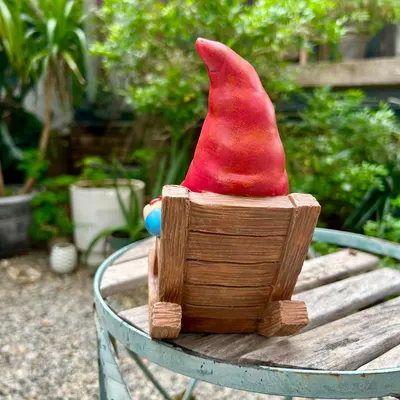 Shows the product in a natural outdoor setting to demonstrate its use as a decorative garden ornament.