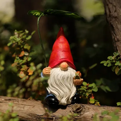 Shows the product in a natural garden setting to demonstrate its use as outdoor decor and appeal to garden enthusiasts.