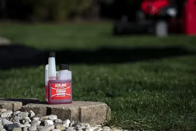 Shows the product being used in an outdoor setting, suggesting its suitability for lawn and garden equipment maintenance.