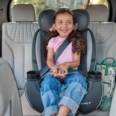 Shows a happy child securely seated in a car seat, demonstrating the product's safety and comfort for family travel.