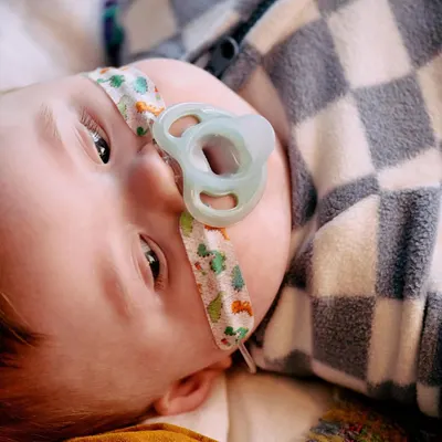 Shows the product in use by a real baby, demonstrating its comfort and suitability for infants.