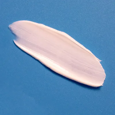Demonstrates the product's creamy, smooth texture to highlight its easy application and blendability.