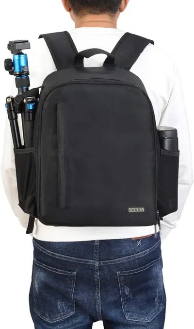 Demonstrates the backpack's ability to securely store and transport camera equipment, highlighting its practical use for photographers.