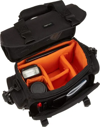 Shows the interior organization and capacity of the camera bag, highlighting its ability to safely store camera equipment and accessories.