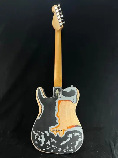 Showcases the guitar's distinctive aesthetic with a unique paint job or finish, highlighting its artistic and visual appeal to potential buyers.