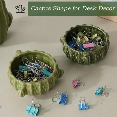 Demonstrates how the cactus-shaped containers can be used for organizing small office supplies like binder clips, enhancing desk decor.