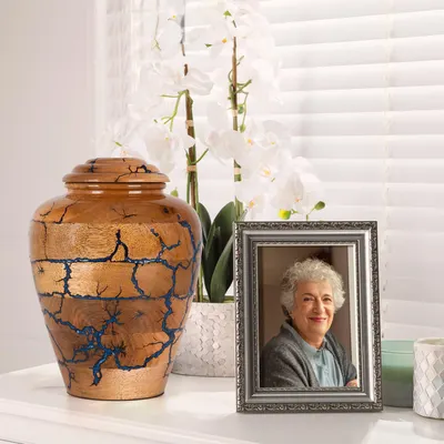 Showcases a decorative urn and photo frame as part of a memorial or remembrance set, helping customers understand the included items for honoring a loved one.