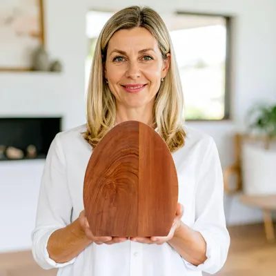 Shows the product in a real-world context, held by a smiling woman in a home setting to convey quality and customer satisfaction.