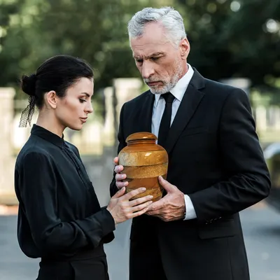 Shows the product in use during a solemn funeral setting, conveying its role in memorial services.