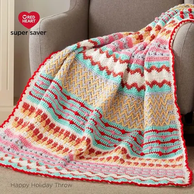 Highlights the Red Heart brand and showcases their colorful yarn product in the form of a crocheted throw blanket.