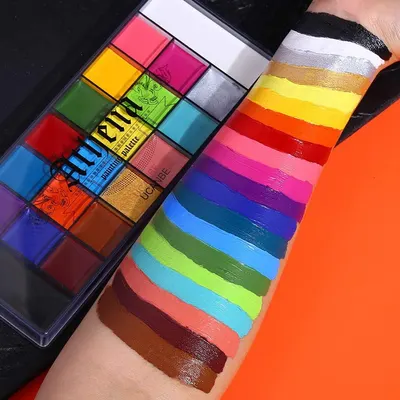 Showcases the wide variety of bold, pigmented colors available in the makeup palette through swatches on skin.