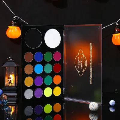 Showcases a colorful eyeshadow palette with Halloween-inspired decorations to appeal to customers looking for festive makeup options.