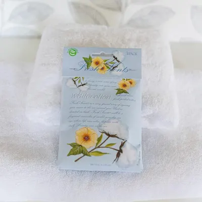 Showcases the product's packaging and branding, emphasizing a natural, fresh scent with floral imagery.