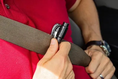 Highlights the product's safety feature of being able to quickly cut a seatbelt in an emergency situation.