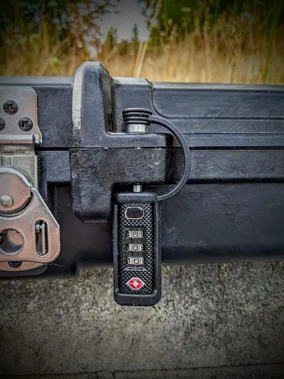 Demonstrates the luggage's built-in TSA-approved combination lock to reassure travelers that their belongings can be secured during travel.