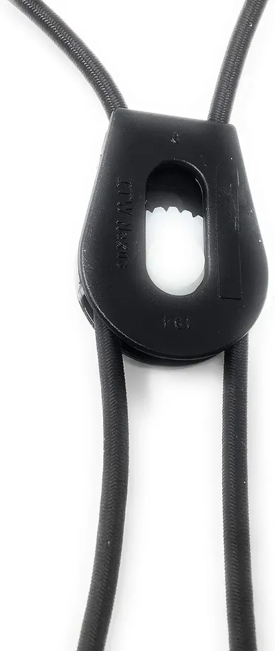 Highlights the specific structural component of the cord lock device, showing how the cords thread through the mechanism to allow for adjustment and tensioning.