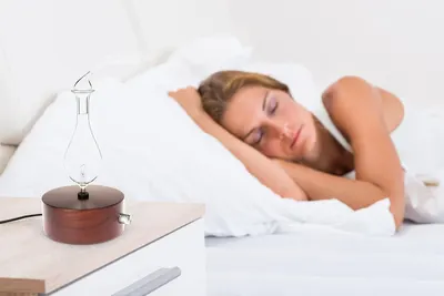 Demonstrates the product being used in a bedroom setting to show its application as a nighttime or sleep-enhancing device.