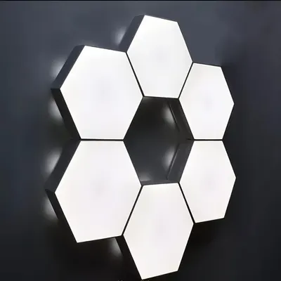 Shows the product installed in a real-world setting to help shoppers visualize how the hexagonal light panels look when mounted on a wall in their own space.
