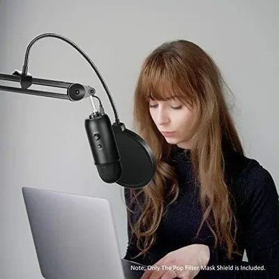 Demonstrates the product in a real-world use case showing a person using the microphone with a pop filter for content creation or recording.