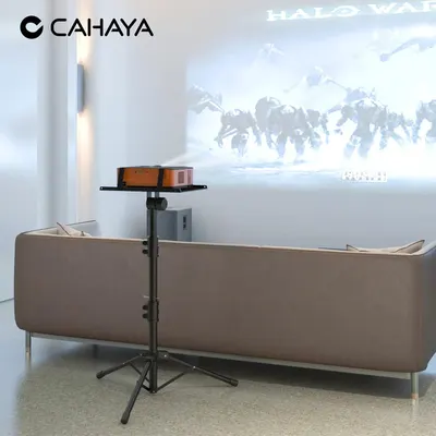 Shows the projector in a real-world living room setting to help shoppers visualize how the product fits into their home and creates a cinema experience.