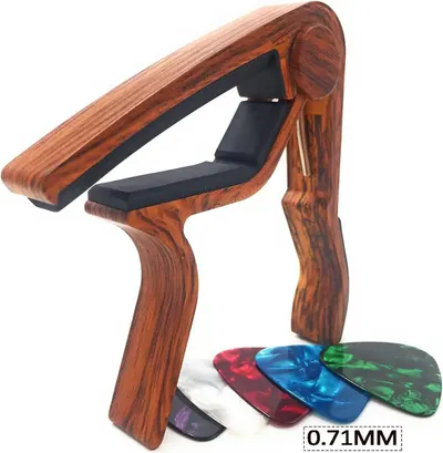 Shows the customer everything they receive with their purchase, including the wooden guitar capo and multiple colorful guitar picks, helping them understand the complete value of the bundle.