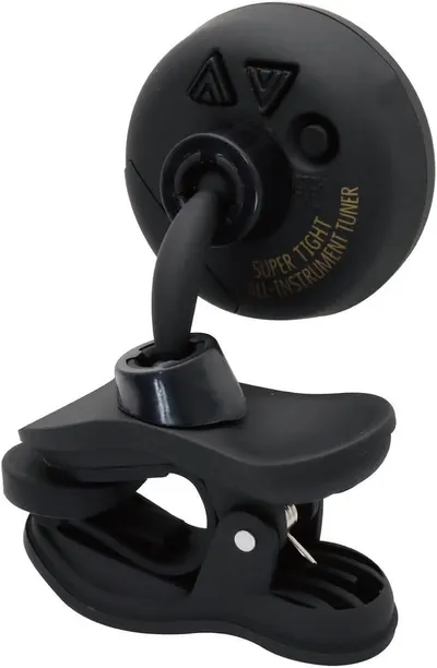 Shows the instrument tuner clipped onto a surface in a real-world setting to help shoppers visualize how the product looks and functions when attached.