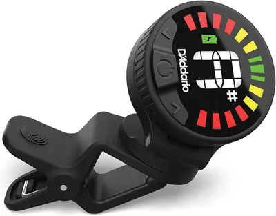 Shows the guitar tuner in a realistic usage context to help shoppers visualize how the product looks and functions when clipped onto an instrument.