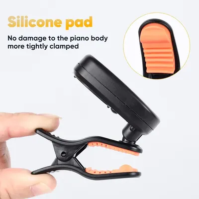 Communicates that the silicone pad prevents damage to the piano body while providing a secure clamp, reassuring customers about safe use.