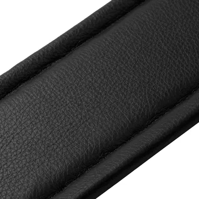 Showcases the high-quality textured leather material to communicate durability and premium craftsmanship to the shopper.