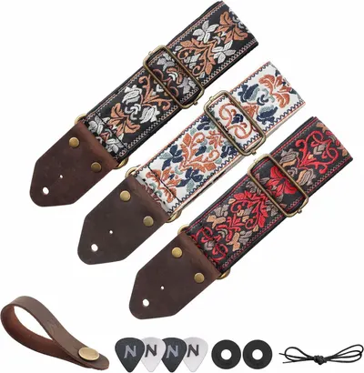 Shows everything included with the purchase: three decorative guitar straps with leather ends, a leather strap holder, guitar picks, strap locks, and a string winder to demonstrate the complete…