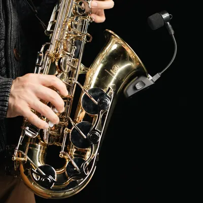 Shows the saxophone being played in a real-world context to help shoppers visualize themselves using the instrument and understand its size and handling.
