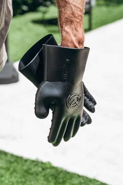 Shows the product being worn in a real-world outdoor setting to help shoppers visualize how the gloves look and fit during actual use.