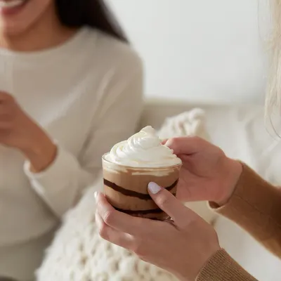 Shows the product being enjoyed in a real-world social setting to help shoppers visualize using it with friends or family in a comfortable home environment.