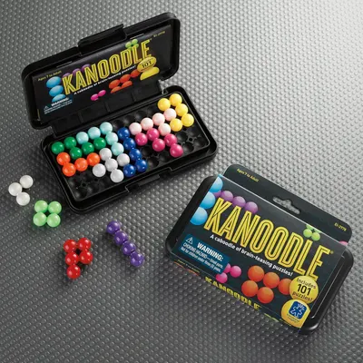 Shows everything included in the package—the puzzle pieces in multiple colors, the storage case, and the puzzle booklet—to help shoppers understand the complete contents and value of the purchase.