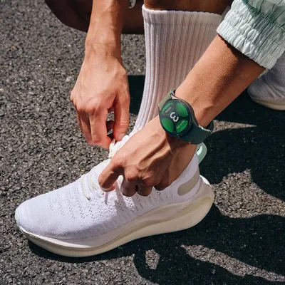 Demonstrates the product in a real-world athletic setting to help shoppers visualize the smartwatch as part of an active lifestyle.