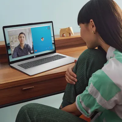 Demonstrates the product in a real-world home office setting, showing how it enables video calls and remote communication in a natural, relatable context.