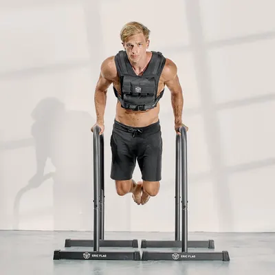 Demonstrates the product in use during an intense workout scenario, showing the weighted vest being worn during a challenging exercise to help shoppers visualize real-world application.