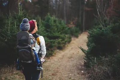Demonstrates the product in a real-world outdoor hiking context to help shoppers visualize using it during outdoor adventures and family activities.