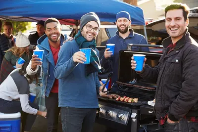Showcases the product in a real-world tailgating or outdoor party setting to help shoppers visualize using it for social gatherings and entertaining.