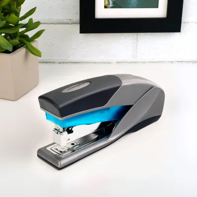 Showcases the stapler in a real-world desktop environment to help shoppers visualize the product in their own workspace.