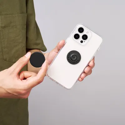 Demonstrates the product's swappable, customizable design feature, showing how users can easily remove and replace the PopSocket accessory to personalize their phone case.