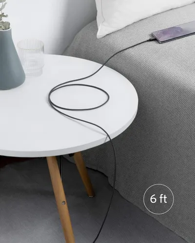 Communicates that the charging cable is 6 feet long, reassuring shoppers they'll have sufficient reach from outlet to bedside or other use locations. Shows the product in a real-world bedroom…